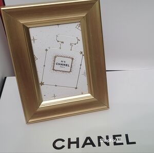 Chanel frame in gold display case